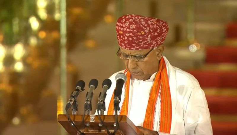 Bhagirath Choudhary reads the oath at a lectern at Rashtrapati Bhavan